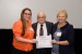 Dr. Nagib Callaos, General Chair, giving Dr. Jennifer Styron and Dr. Sheila Whitworth the best paper award certificate of the session "Knowledge Integration and Inter-Disciplinary Communication II (KCST / EISTA / IMSCI) ." The title of the awarded paper is "Interprofessional Collaborative Practice to Improve Patient Outcomes: A Pilot Study."